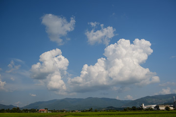 The white clouds have a strange shape and mountain