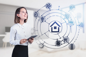 Smiling woman with tablet, smart home interface