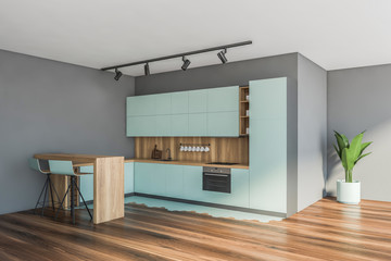 Blue and gray kitchen corner with bar