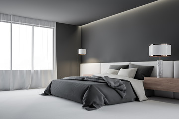 Gray master bedroom corner with lamp