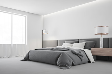White master bedroom corner with lamp