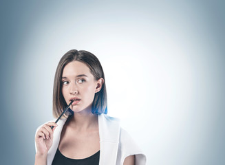 Fototapeta premium Thoughtful casual woman with pencil, mock up