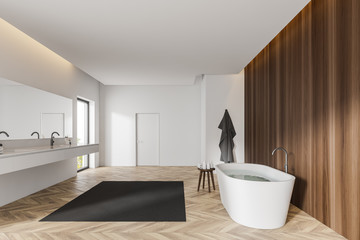 White and dark wooden bathroom with door