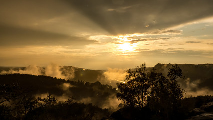 View from Gamrig over the foggy Elbe valley in Saxon Switzerland at sunset