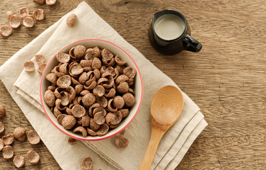 Cereals breakfast cocoa flavor in bowl on wooden backdrop with copy space,top view