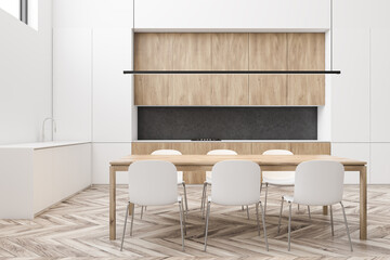White dining room and wooden kitchen interior