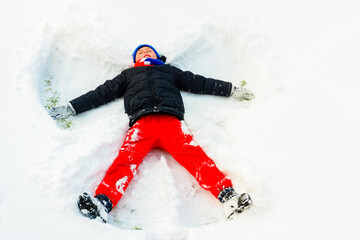 Fototapeta na wymiar An angel in the snow made by a boy.