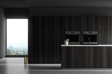 Kitchen with dark wooden island and two ovens