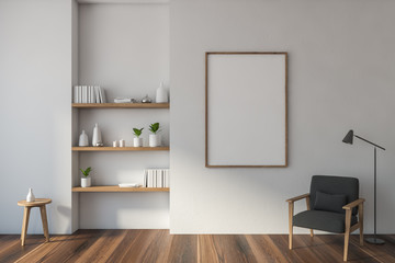 White living room with armchair, shelves, poster