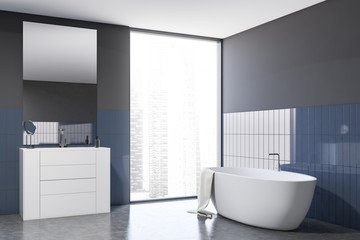 Gray and blue tile bathroom with tub and sink