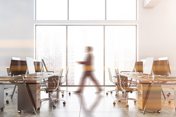 Blurry businessman walking in white office