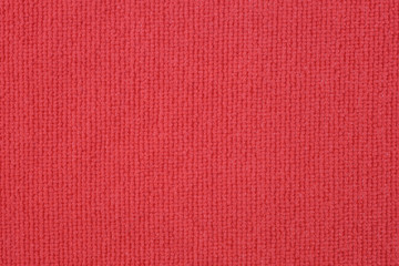 Close up of red colored wool textile texture abstract background