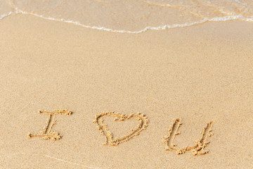 Valentine's day on a sunny beach. Text I love you. Declaration of love painted on the sand. Love concept. Relax on the sandy beach. Copy space.