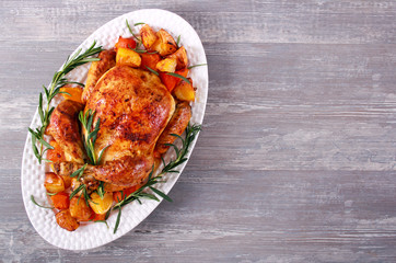 Roast whole chicken with vegetables and rosemary