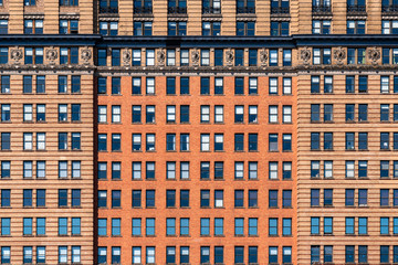 Brown Brick high building facade with windows in New York City, United states of America, USA, Industrial Background and texture, Loft inspiration. Construction facade, history and culture concept