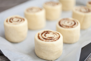 Raw Cinnamon rolls. Preparation process - unbaked dough, waiting before baking 