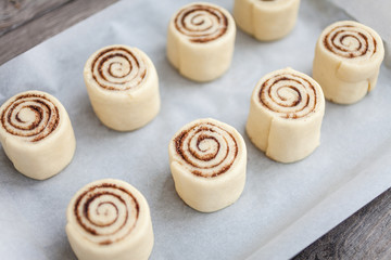Raw Cinnamon rolls. Preparation process - unbaked dough, waiting before baking 