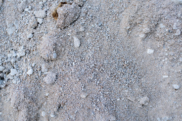 A large pile of gray sand. Background. Texture.