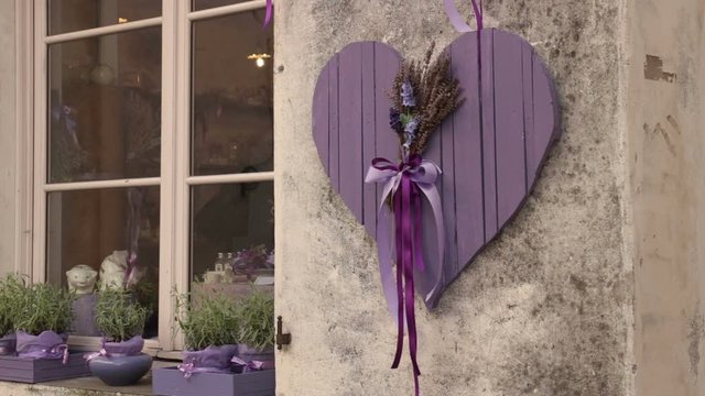 wooden heart shape, outdoor decoration of a traditional italian shop that selles lavender products