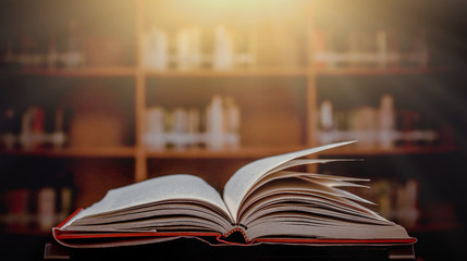 Stack of books in the library and blur bookshelf background