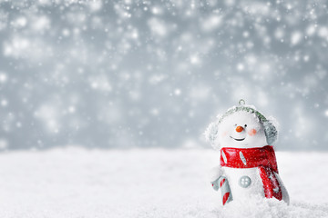 Snowman toy on winter background