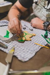 Fototapeta premium closeup of hands decorating christmas cookies