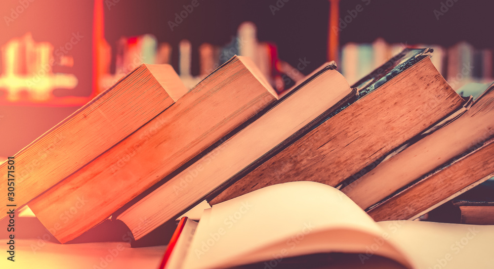 Poster stack of books in the library and blur bookshelf background