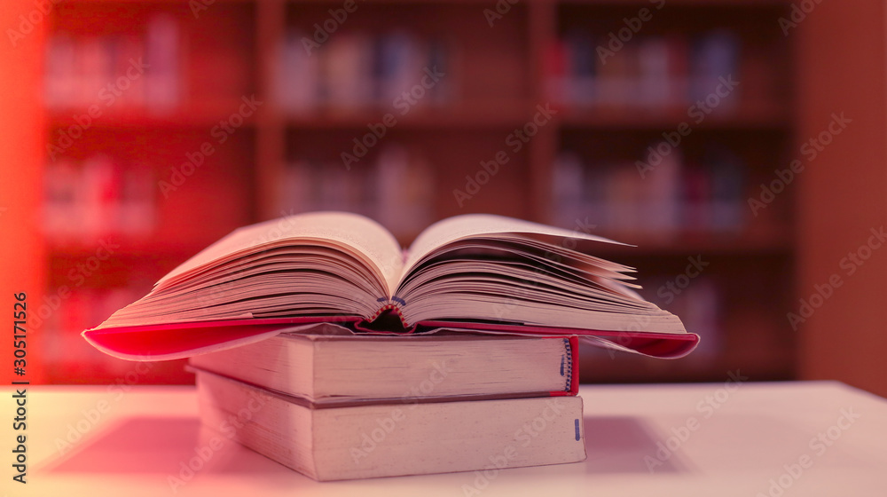 Poster stack of books in the library and blur bookshelf background