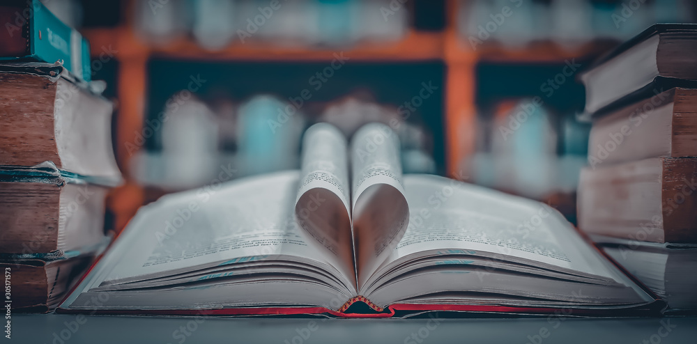 Poster stack of books in the library and blur bookshelf background