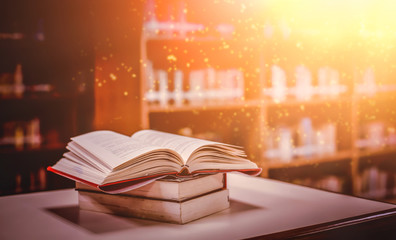 Imagine a picture book of an ancient book opened on a wooden table with a sparkling golden...