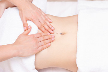 Fototapeta na wymiar Massage Therapist Massaging a Womens Stomach. Massage and body care. Spa body massage woman hands treatment.
