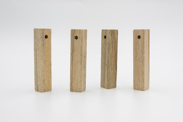 4 rectangular perforated wooden blocks neatly standing upright isolated on white background