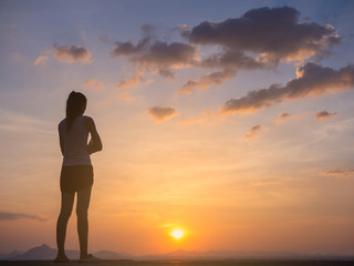 Fototapeta premium Free young woman at golden sunset. Freedom and success concept,relaxing and enjoying nature with copy space.