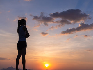 Free young woman at golden sunset. Freedom and success concept,relaxing and enjoying nature with copy space.