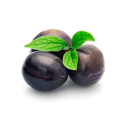 Group of plums with plum leaves isolated on a white background.