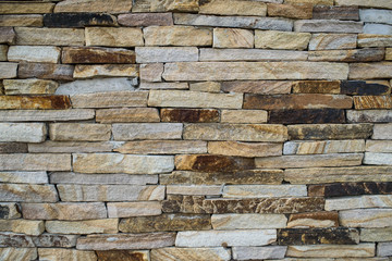 A wall of beautiful stone on the street. Background. Texture.