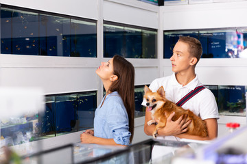 Nice mother and boy choosing tropical fish