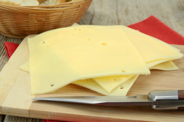 slice of gruyere on a cutting board