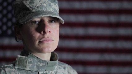 American female soldier against an American flag