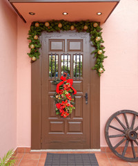 Fototapeta na wymiar house Christmas decorated entrance brown door, Athens Greece