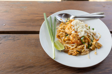 Thai style stir- fried noodles with shrimp and vegetable, Pad Thai,street food in Thailand nation dishes ,on wood background