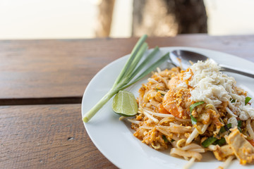 Thai style stir- fried noodles with shrimp crab and vegetable, Pad Thai,street food in Thailand nation dishes ,on wood background
