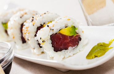 Image of tasty uramaki sushi with raw tuna fish and fresh avocado