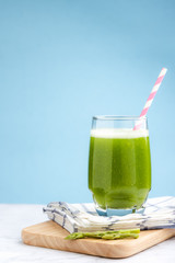 Healthy green smoothie asparagus on cutting board and blue background. food and drink for health concept.