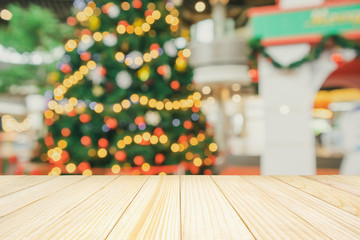Empty wood table top with Abstract blur Christmas tree with decoration bokeh light background for product display