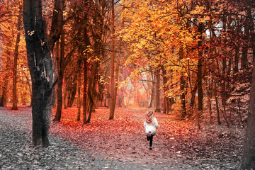 Girl runs into the colored side of life, in the colorful autumn forest 