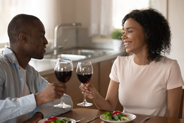 African American couple enjoy romantic dinner at home