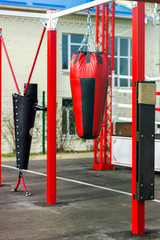 Fototapeta na wymiar Image of an outdoor training room with punching bags of various shapes for martial arts. Healthy lifestyle concept.
