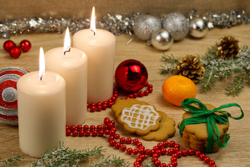 three burning candles with Christmas decoration. xmas composition.