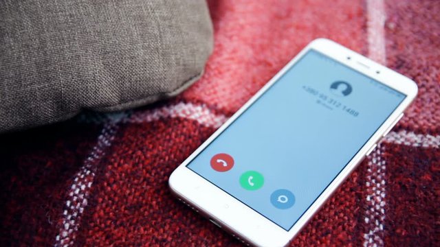 Call on mobile phone lying on sofa